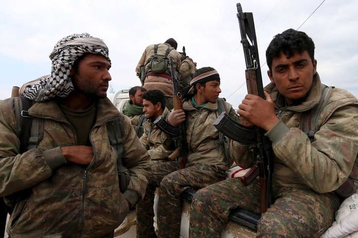 kurdish-people-s-protection-units-ypg-fighters-carry-their-weapons-while-riding-on-the-back-of-a-pick-up-truck-in-qamishli_5566163_1157_771