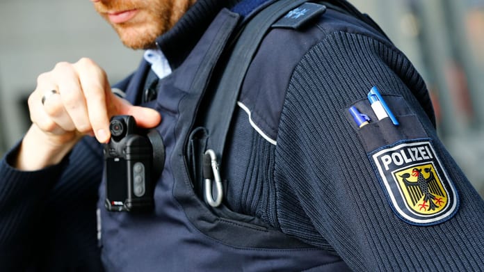 a-federal-police-officer-of-germany-s-bundespolizei-adjusts-the-lens-of-his-so-called-body-cam-while-patrolling-at-the-main-railway-station-in-cologne_5511215
