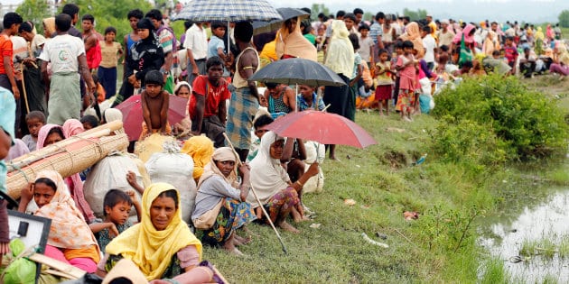 Rohingya refugees are seen waiting for a boat to cross the border through the Naf river in Maungdaw, Myanmar