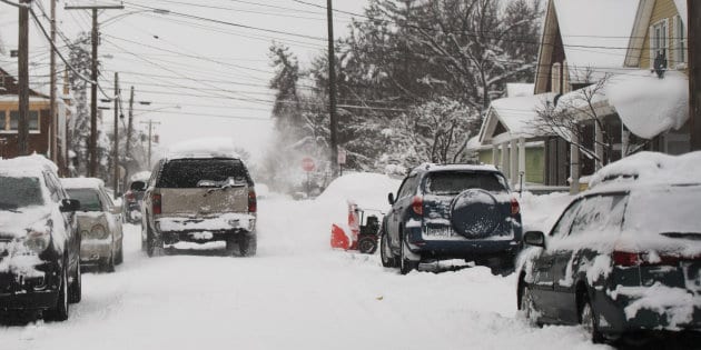 Residents dig out cars after two days of record-breaking snowfall in Erie
