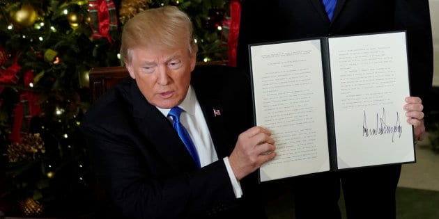 U.S. President Donald Trump displays an executive order after he announced the U.S. would recognize Jerusalem as the capital of Israel, in the Diplomatic Reception Room of the White House in Washington