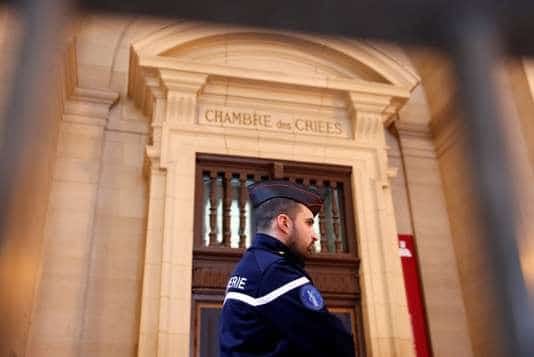 A French gendarme waits for the start of the trial of Jawad Bendaoud, the man accused of housing the suspected planner of the November 2015 attacks, at the courts in Paris
