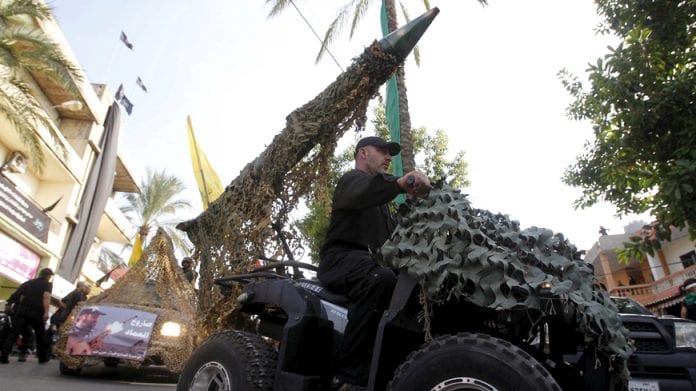 Hezbollah member drives a 4-wheel motorbike mounted with a mock rocket during a re-enactment of the battle of Kerbala during a mourning process, ahead of the day of Ashoura, in Saksakieh village, southern Lebanon