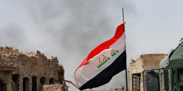 An Iraqi flag is seen during the fight with the Islamic States militants in the Old City of Mosul