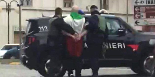 The suspected shooter that opened fire on African migrants, identified as Luca Traini, 28, is seen detained by Italian Carabinieri in Macerata