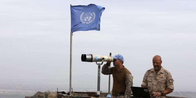 UN soldiers look out on a post at Mount Avital, in the Israeli-occupied Golan Heights near the Israeli Syrian border