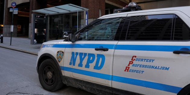 A New York Police Department car stands parked outside of a building containing IBT Media, parent company of Newsweek Media Group, in New York