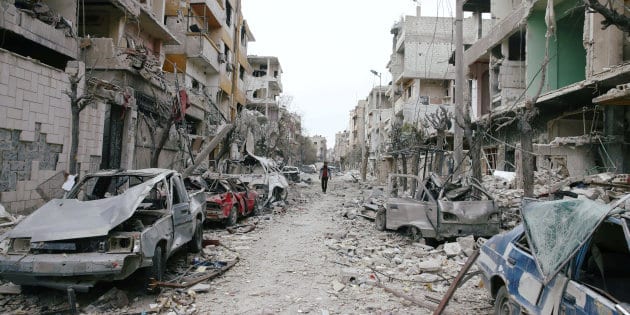 Damaged cars and buildings are seen in the besieged town of Douma, Eastern Ghouta, Damascus