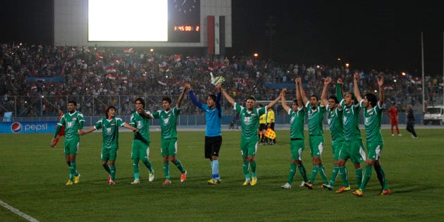 Iraq's players acknowledge their fans after their international friendly soccer match against Syria in Baghdad