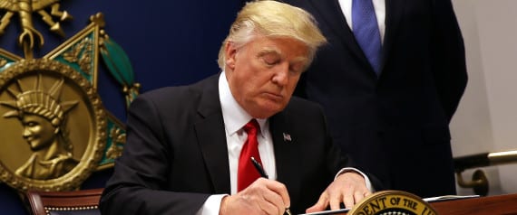 U.S. President Donald Trump signs an executive order to impose tighter vetting of travelers entering the United States, at the Pentagon in Washington