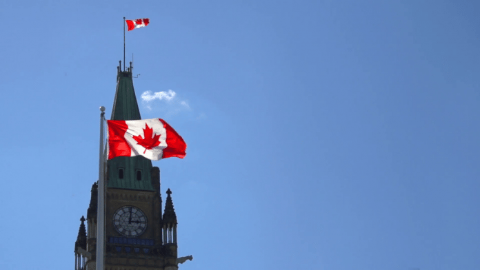 flags-outside-the-ottawa-parliament-peace-tower-canada-slow-motion_espmjs9cx__F0010-1024x576