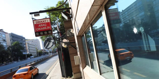 Impacts of bullets are seen in a window of the U.S. Embassy in Ankara