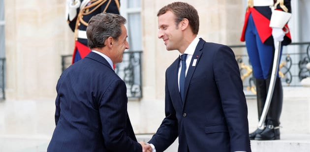 French President Emmanuel Macron greets former French president Nicolas Sarkozy at the Elysee Palace in Paris
