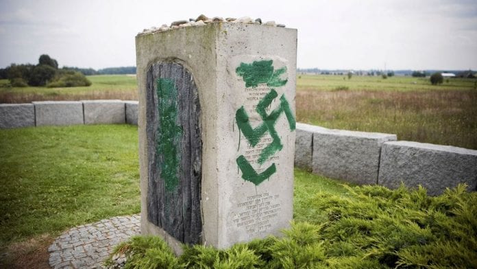 a-man-uses-a-pressure-hose-to-clean-the-monument-with-nazi-swasticas-painted-over-it-in-jedwabne_6159186