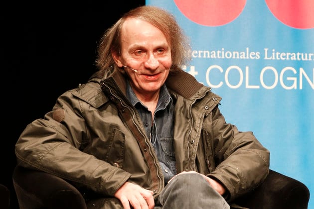 French author Houellebecq sits on stage of the Schauspiel Koeln, the public theater of the western German city of Cologne