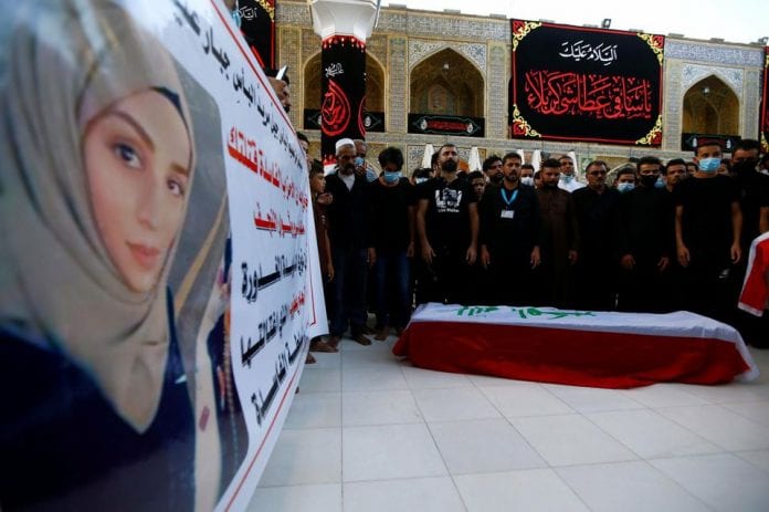 1331529-mourners-pray-near-the-coffin-of-reham-yacoub-a-female-activist-who-was-killed-by-unidentified-gunme