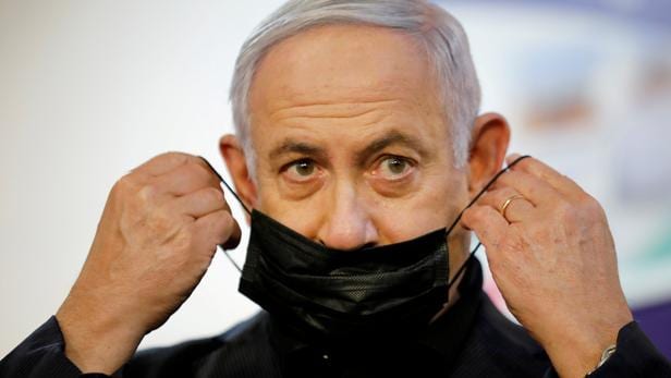 FILE PHOTO: Israeli Prime Minister Benjamin Netanyahu receives COVID-19 vaccine