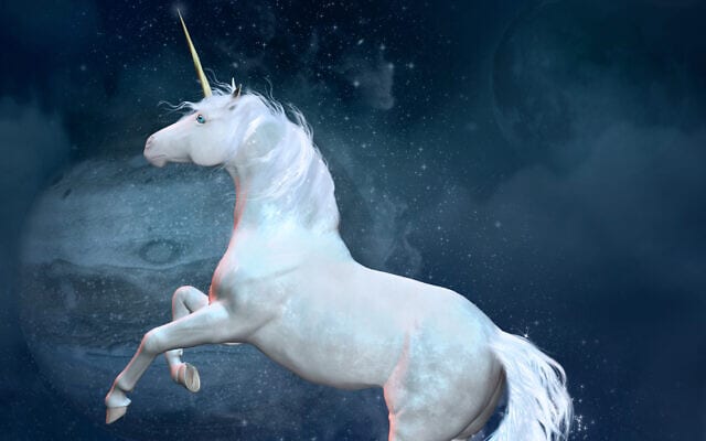 Fantasy unicorn over a rock