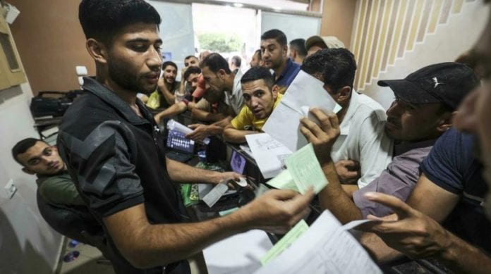 palestinian_men_gather_to_apply_for_work_permits_in_israel_at_jabalia_refugee_camp_in_the_northern_gaza_strip._afp