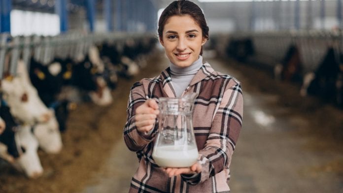 young-woman-standing-with-milk-jug