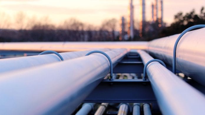 steel long pipes in crude oil factory during sunset
