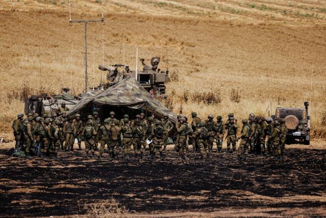 Israeli soldiers of an artillery unit gather near the border between Israel and the Gaza Strip, on its Israeli side