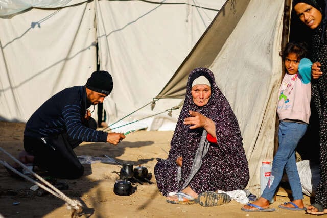 Displaced Palestinians shelter in a tent camp in Rafah