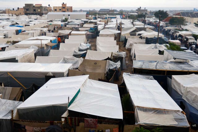 Displaced Palestinians shelter in a tent camp, in Khan Younis
