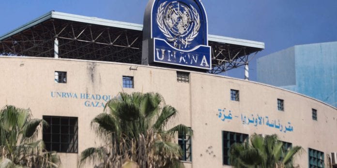 Palestinians gather to inspect the damages at the headquarters of UNRWA in Gaza City