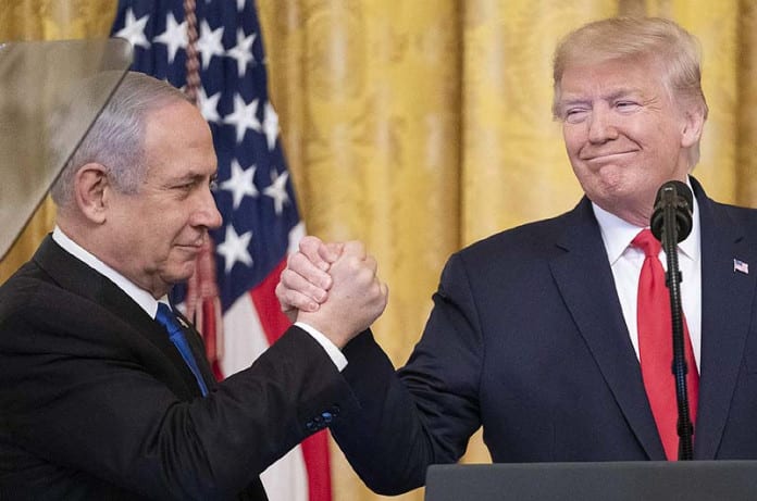 President-Donald-J.-Trump-attempts-a-winners’-handshake-with-Israeli-Prime-Minister-Benjamin-Netanyahu-in-the-East-Room-of-the-White-House-January-28-2020.-696x461