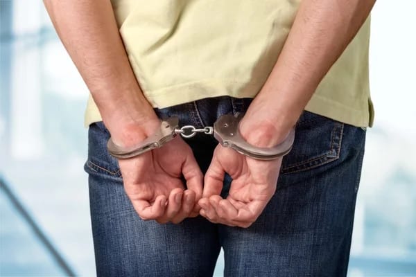 handcuffs-behind-his