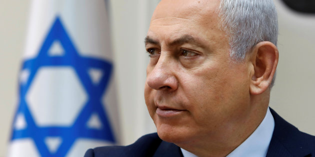 Israeli Prime Minister Benjamin Netanyahu opens the weekly cabinet meeting at his Jerusalem office