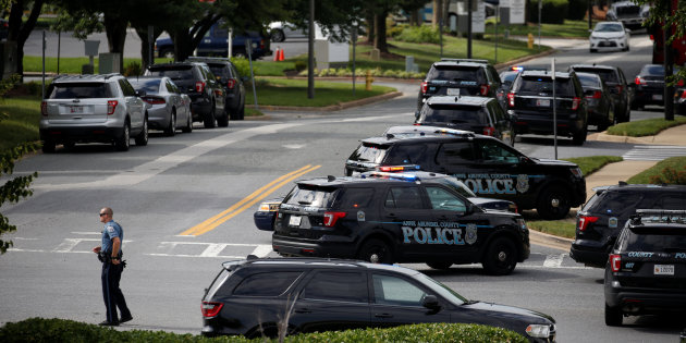 Law enforcement officials survey shooting scene outside Capital Gazette newspaper in Annapolis, Maryland