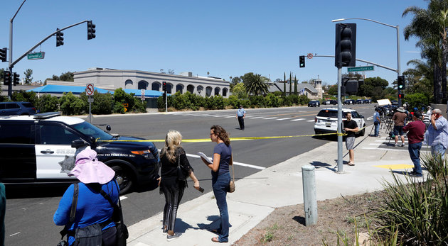 Police secure the scene of a shooting incident at the Congregation Chabad synagogue in Poway