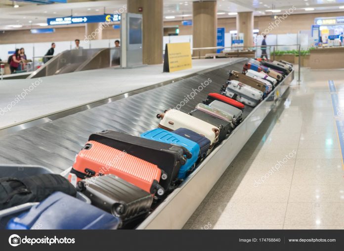 Suitcase or luggage with conveyor belt in the airport.