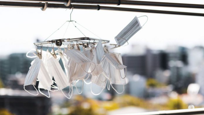 Wash the surgical masks and dry them outdoors.