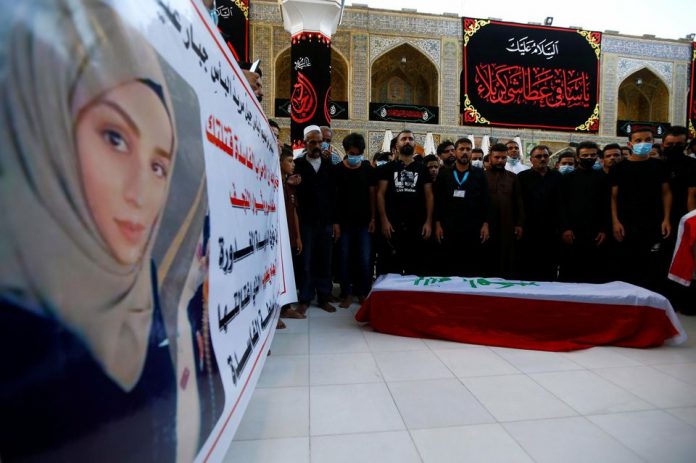 1331529-mourners-pray-near-the-coffin-of-reham-yacoub-a-female-activist-who-was-killed-by-unidentified-gunme