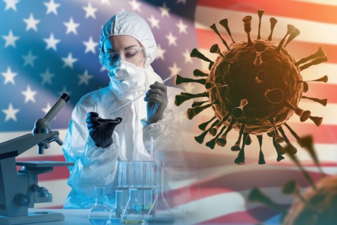 Antiviral laboratory specialist. Man in chemical protection suit. Bacteria near virologist. Pandemic in USA. Virologist with microscope near USA flag. Pandemic in United States. Coronavirus, covid-19