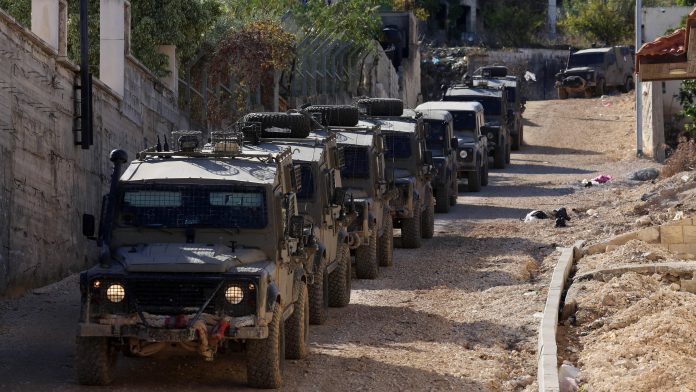 (231129) -- JENIN, Nov. 29, 2023 -- Israeli military vehicles are seen during a raid in the West Bank city of Jenin, on