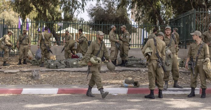 Soldiers in an assembly area near the Gaza Strip in Israel, on Oct. 8, 2023. (Avishag Shaar-Yashuv/The New York Times)