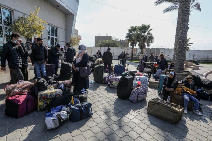 Palestinians,Holding,Foreign,Passports,Leave,The,Rafah,Crossing,To,The