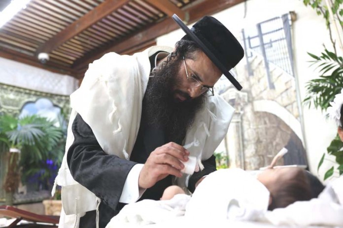 Mohel-Amram-Nizri-preforms-circumcision-on-his-newborn-son-July-6-2023.-696x464