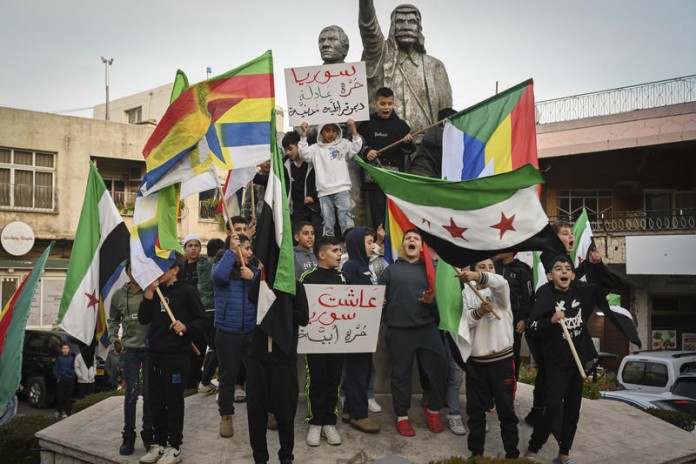 Residents-of-the-Druze-village-of-Majdal-Shams-in-Israel’s-Golan-Heights-celebrated-the-rebels’-takeover-in-Syria-December-9-2024.-696x464